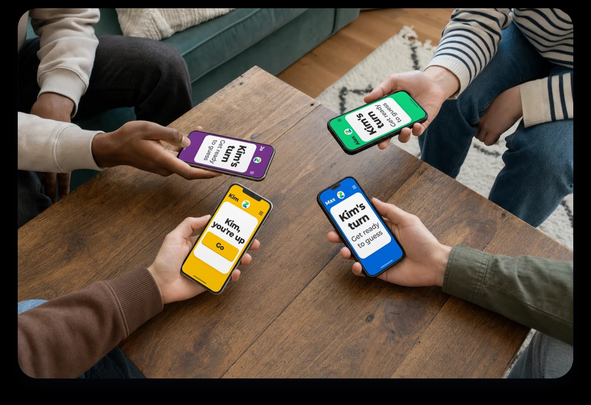 Four hands holding phones over a coffee table, one showing “Kim, you're up”.
